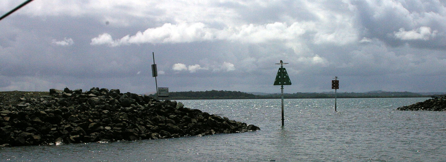 Channel markers and breakwater seen from a ferry at Redland Bay terminal
